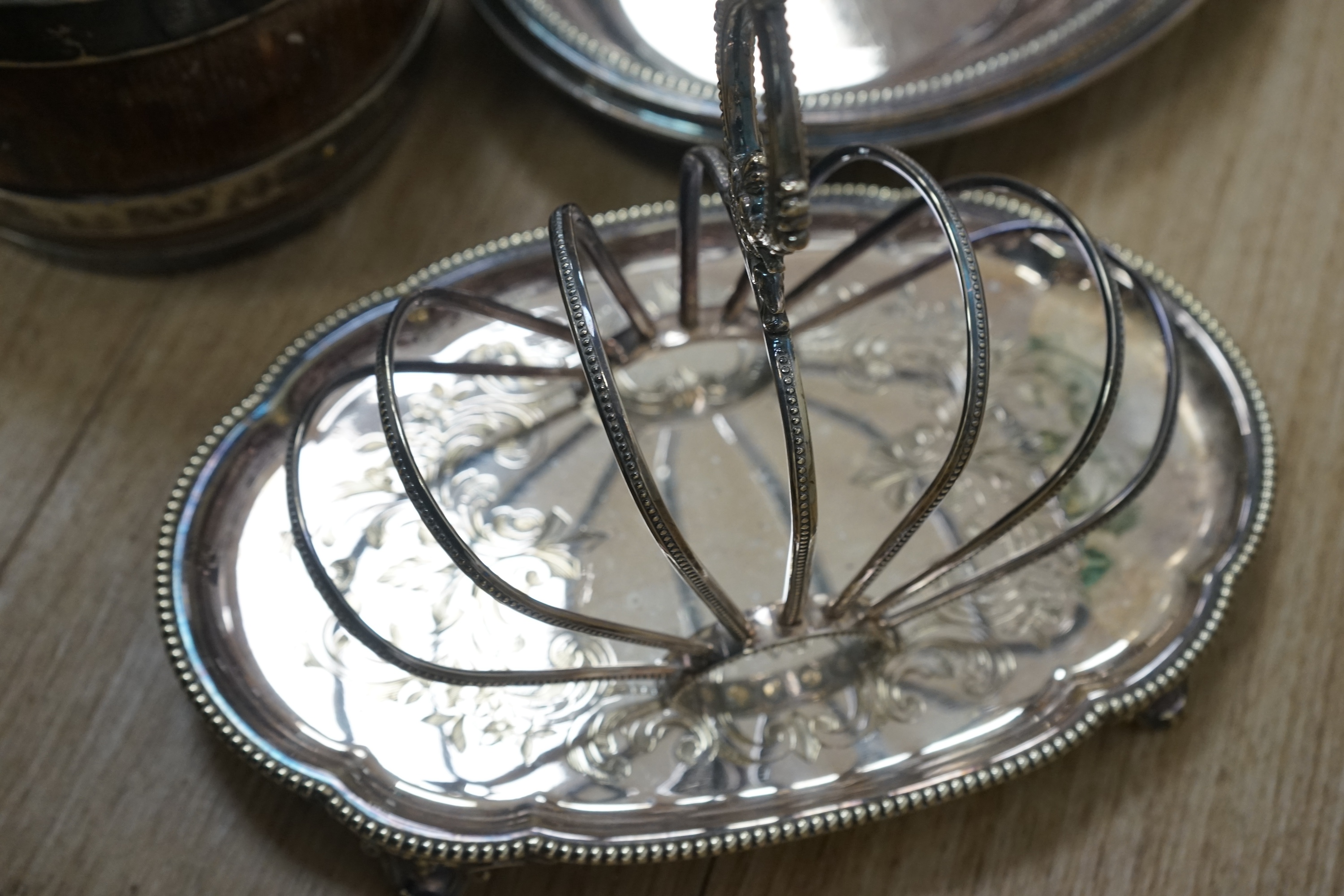 Assorted plated wares to include flatware, toast rack, biscuit barrel and goblet. Condition - fair